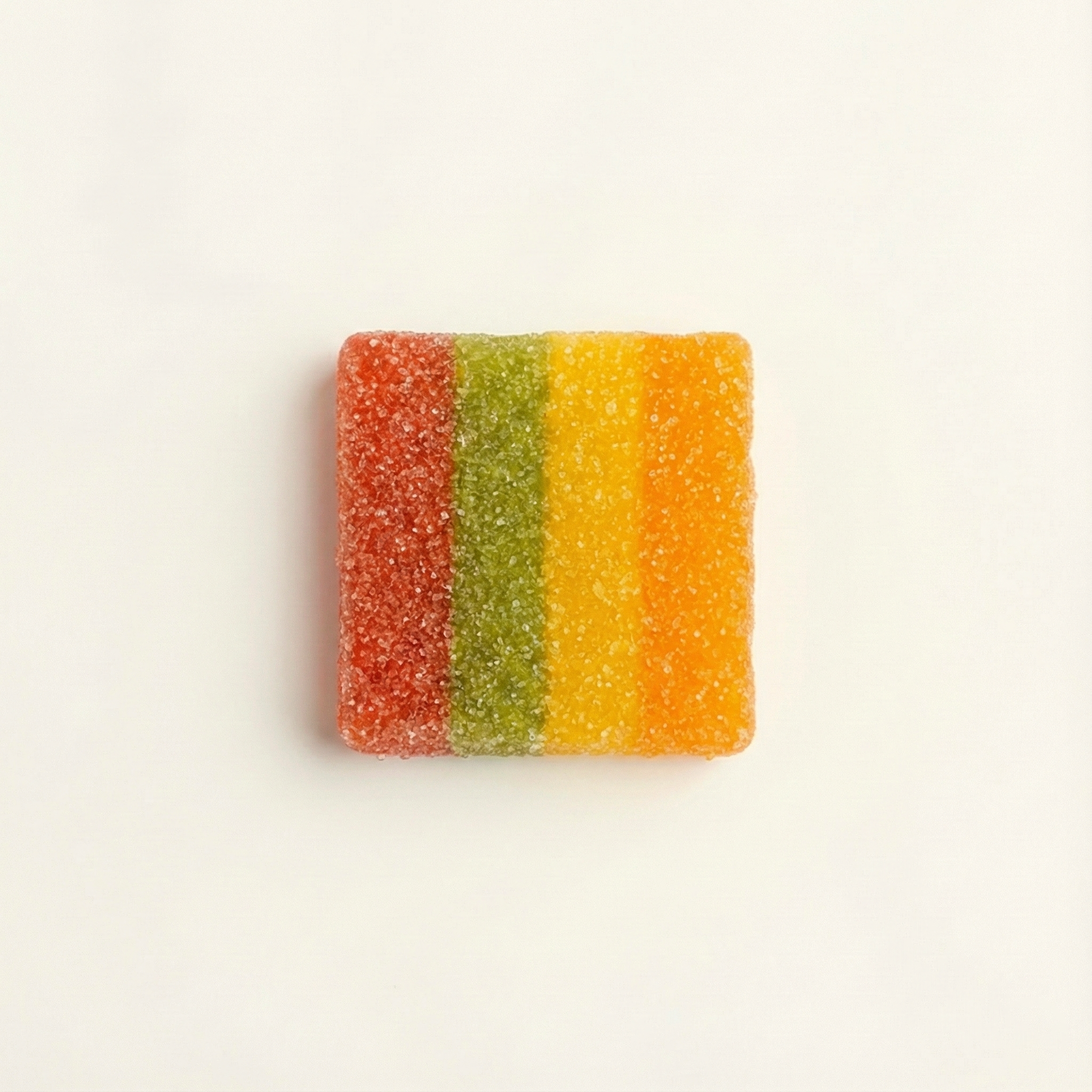 Colorful striped gummy candy on a light beige background
