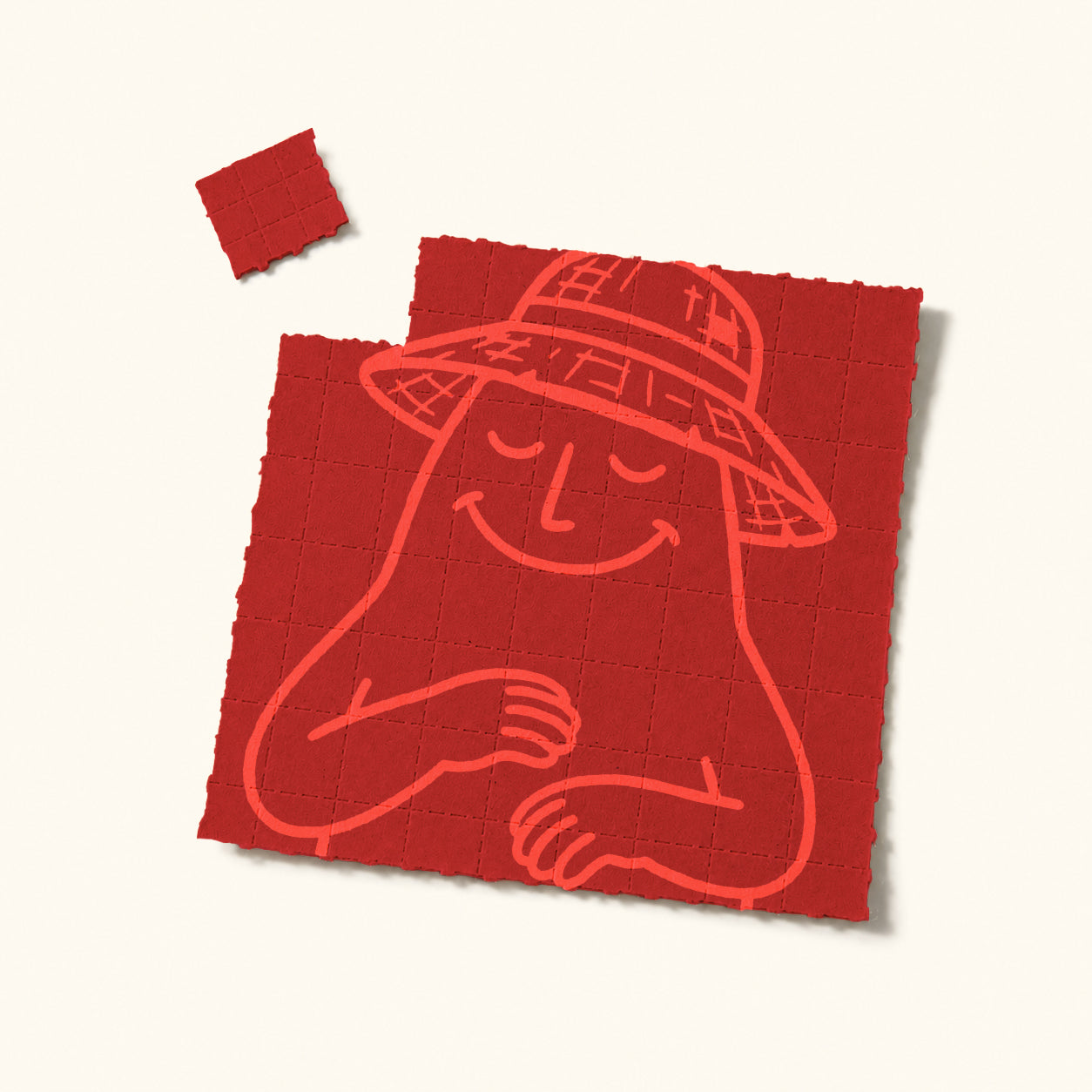 Roter, perforierter MyGreen 4-PRO-MET Blotter-Bogen mit stilisierter Illustration einer lächelnden Figur mit Hut, daneben ein abgetrenntes kleines Quadrat auf hellem Hintergrund.